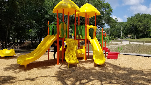 Playground at McLean Park in North Myrtle Beach, SC. Yellow slides for toddlers with mulch covered ground.