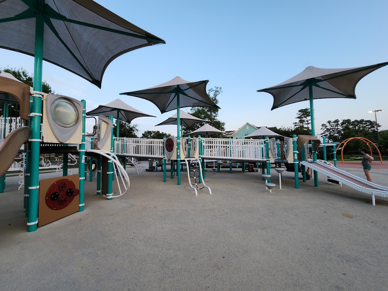 Savannah's Playground in Myrtle Beach, SC. Grey rubber surface with canopy covered stairs and slides.